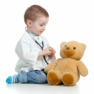 Boy playing doctor with his teddy bear