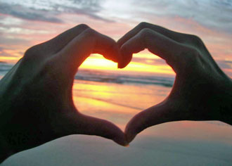 Sunset and making heart with the hands