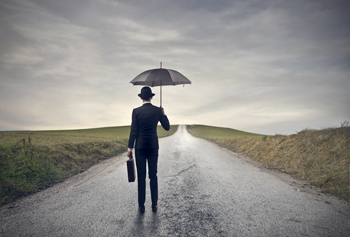 Man with umbrella on a long difficult journey